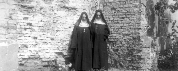 Surviving sisters at the makeshift grave of the sisters who died